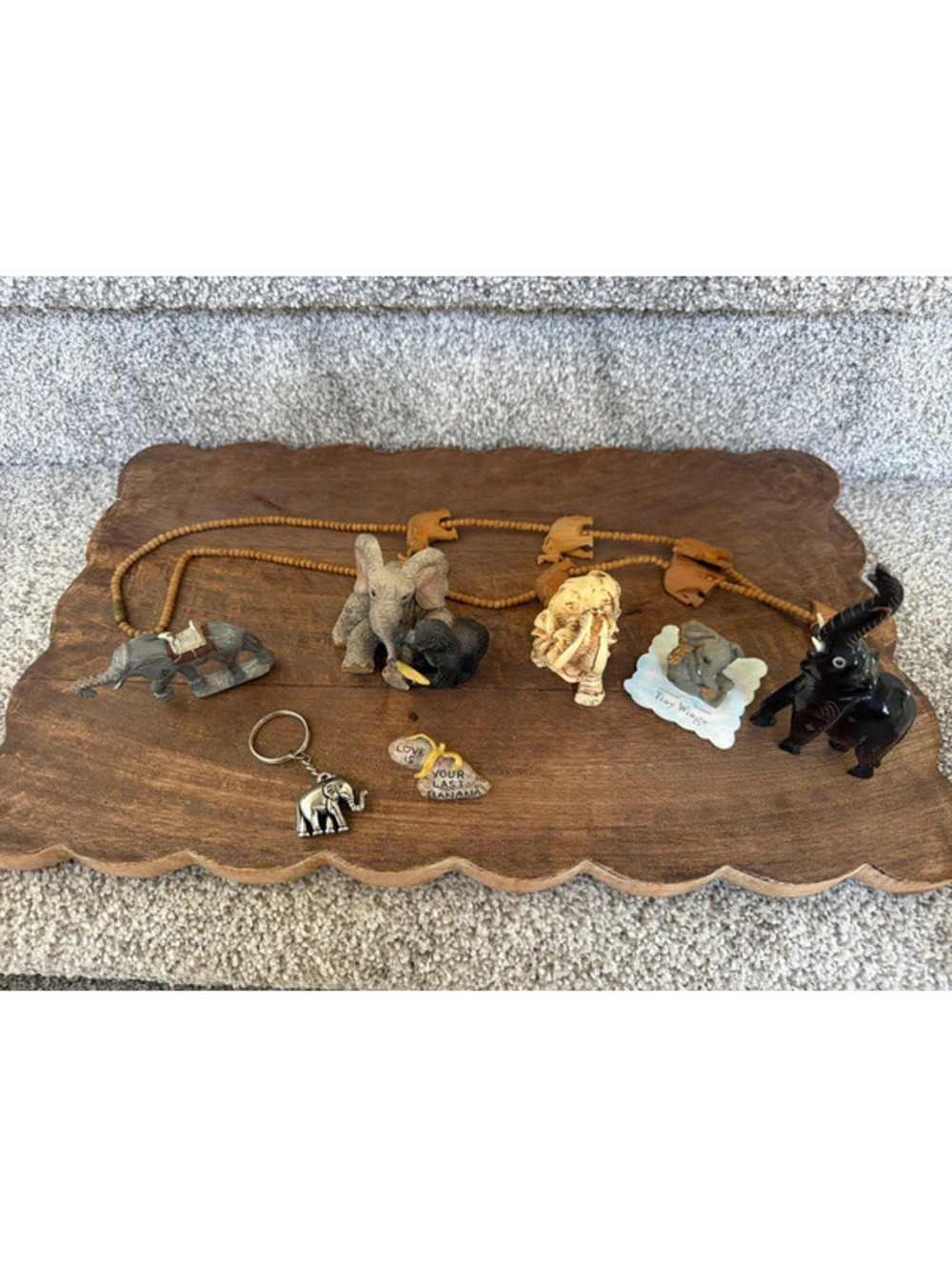 Lot of misc elephant figurines and 1 wooden necklace.